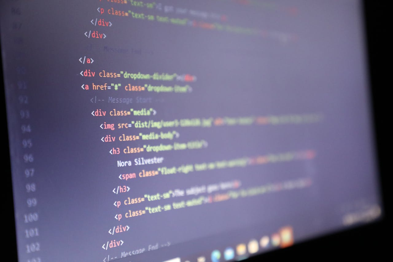 services-04 Illuminated HTML code displayed on a computer screen, close-up view.